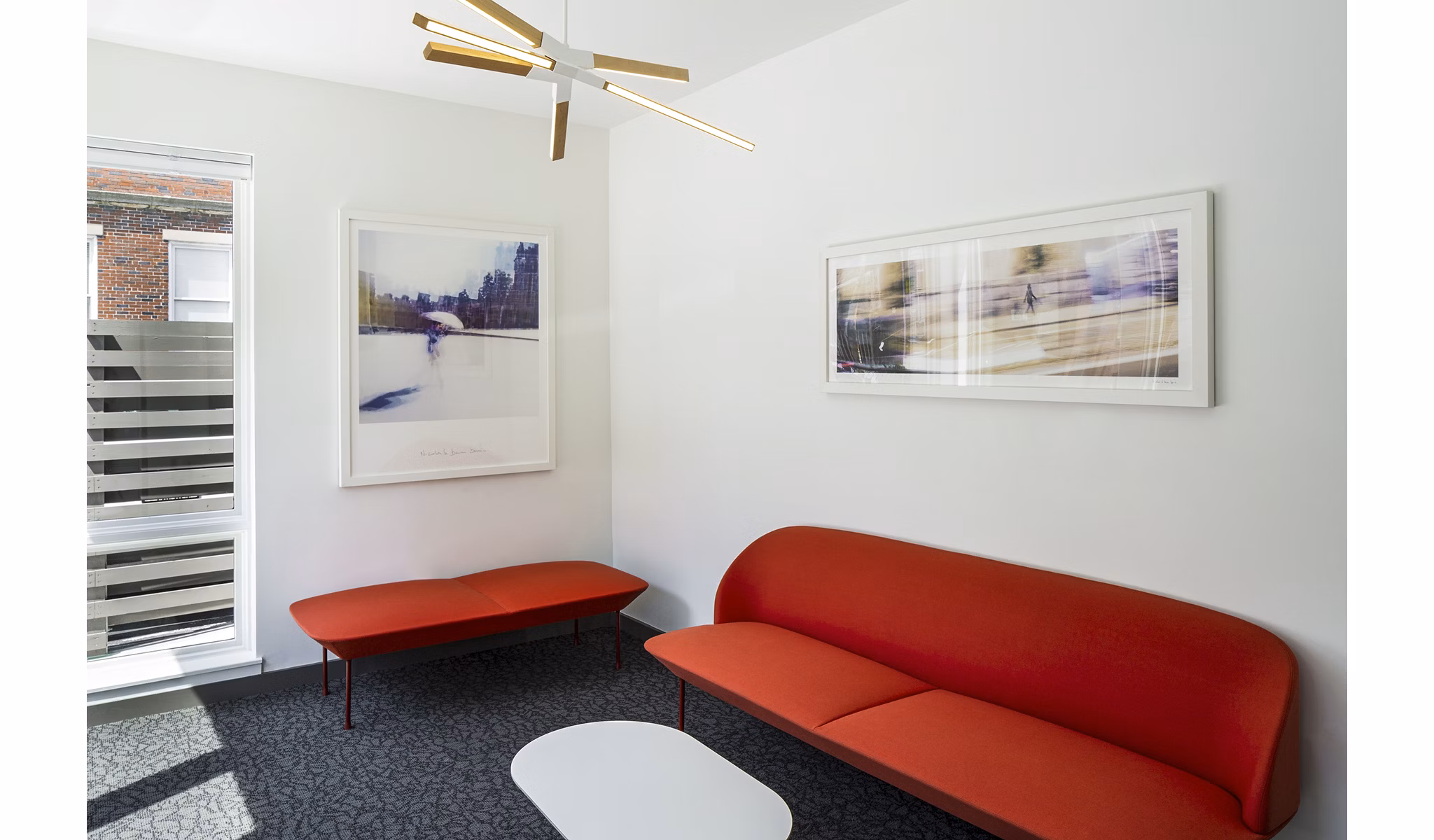 Modern clubhouse with cozy seating and large windows at Union House Apartments, ideal for social gatherings and relaxation