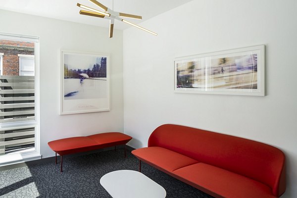 Modern clubhouse with cozy seating and large windows at Union House Apartments, ideal for social gatherings and relaxation