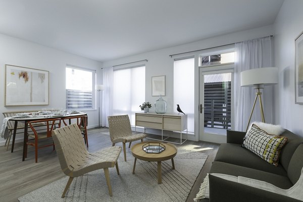 Spacious living room with modern decor and large windows in Union House Apartments
