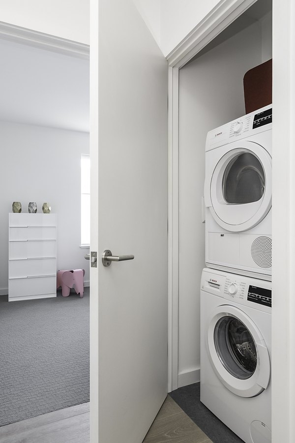 Laundry room with modern washers and dryers in Union House Apartments, a luxury complex designed for convenient city living