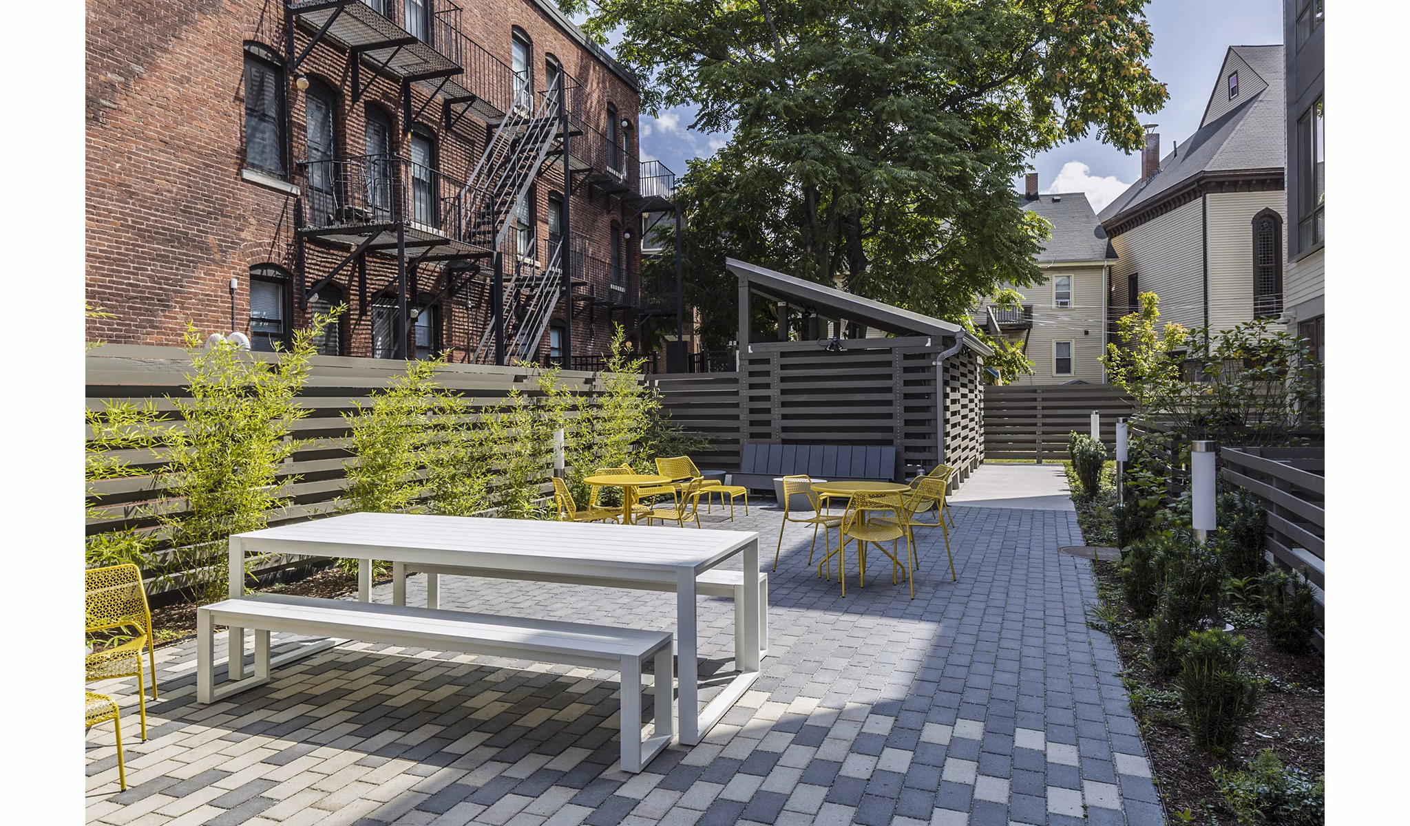Outdoor grill area with modern seating at Union House Apartments provides luxury communal space for residents to enjoy barbecuing and socializing