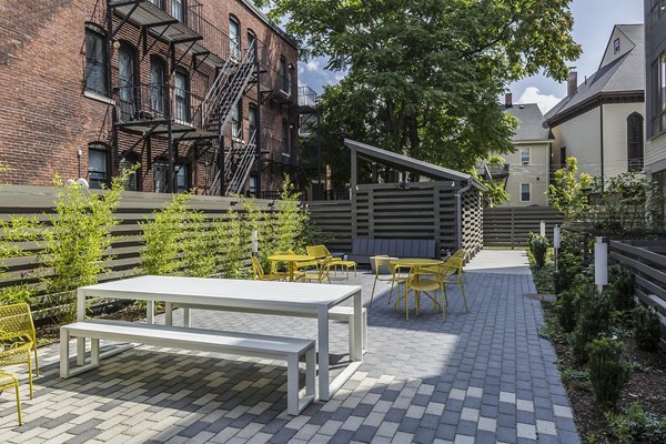 Outdoor grill area with modern seating at Union House Apartments provides luxury communal space for residents to enjoy barbecuing and socializing