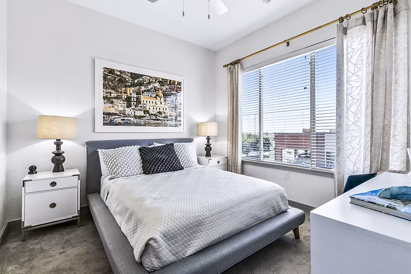 Cozy bedroom with modern decor at West Village Apartments, part of Greystar's luxury apartment offerings