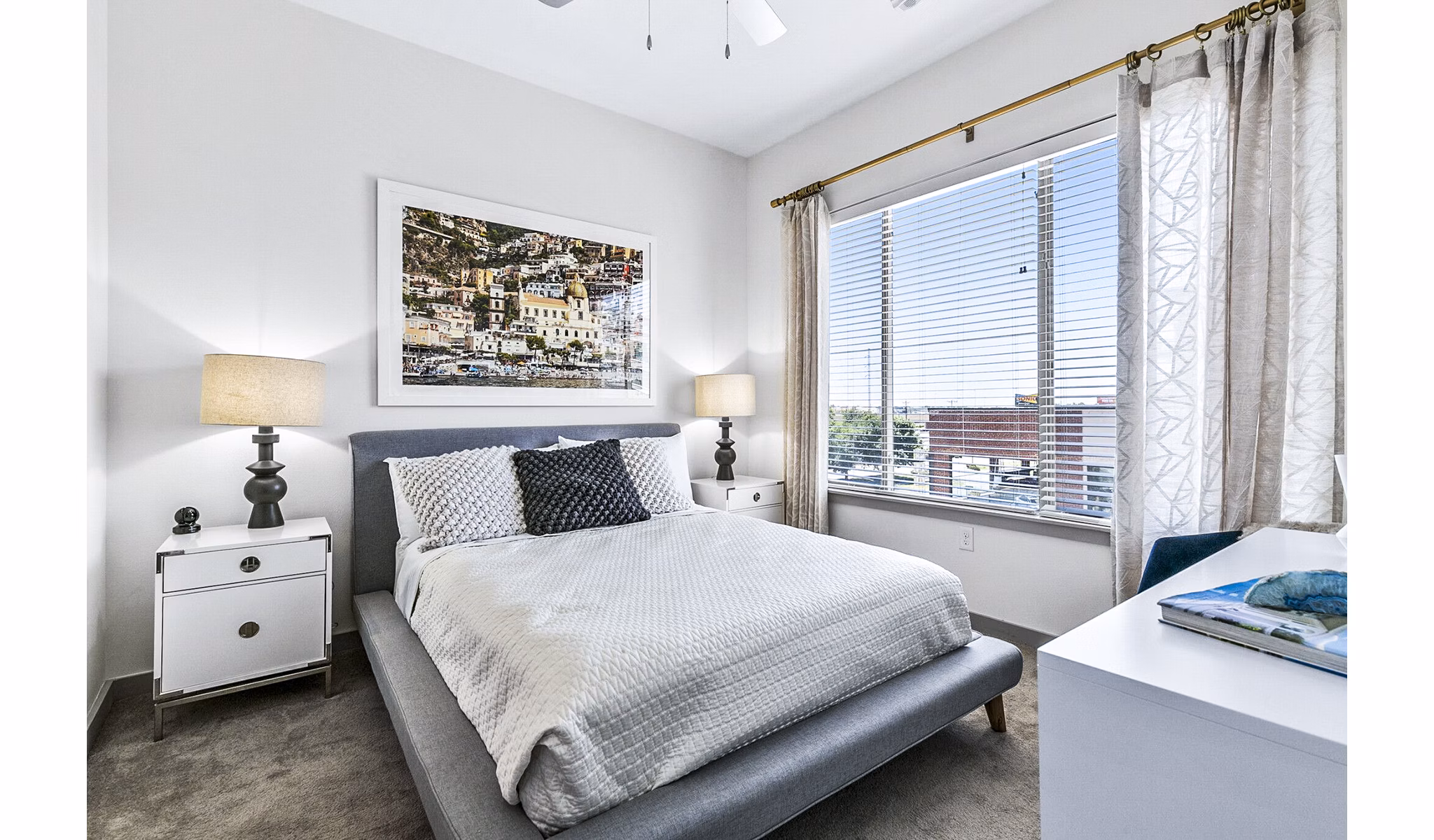 Cozy bedroom with modern decor at West Village Apartments, part of Greystar's luxury apartment offerings