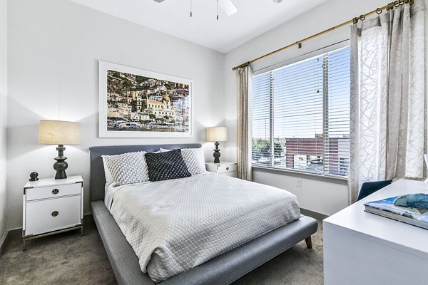 Cozy bedroom with modern decor at West Village Apartments, part of Greystar's luxury apartment offerings