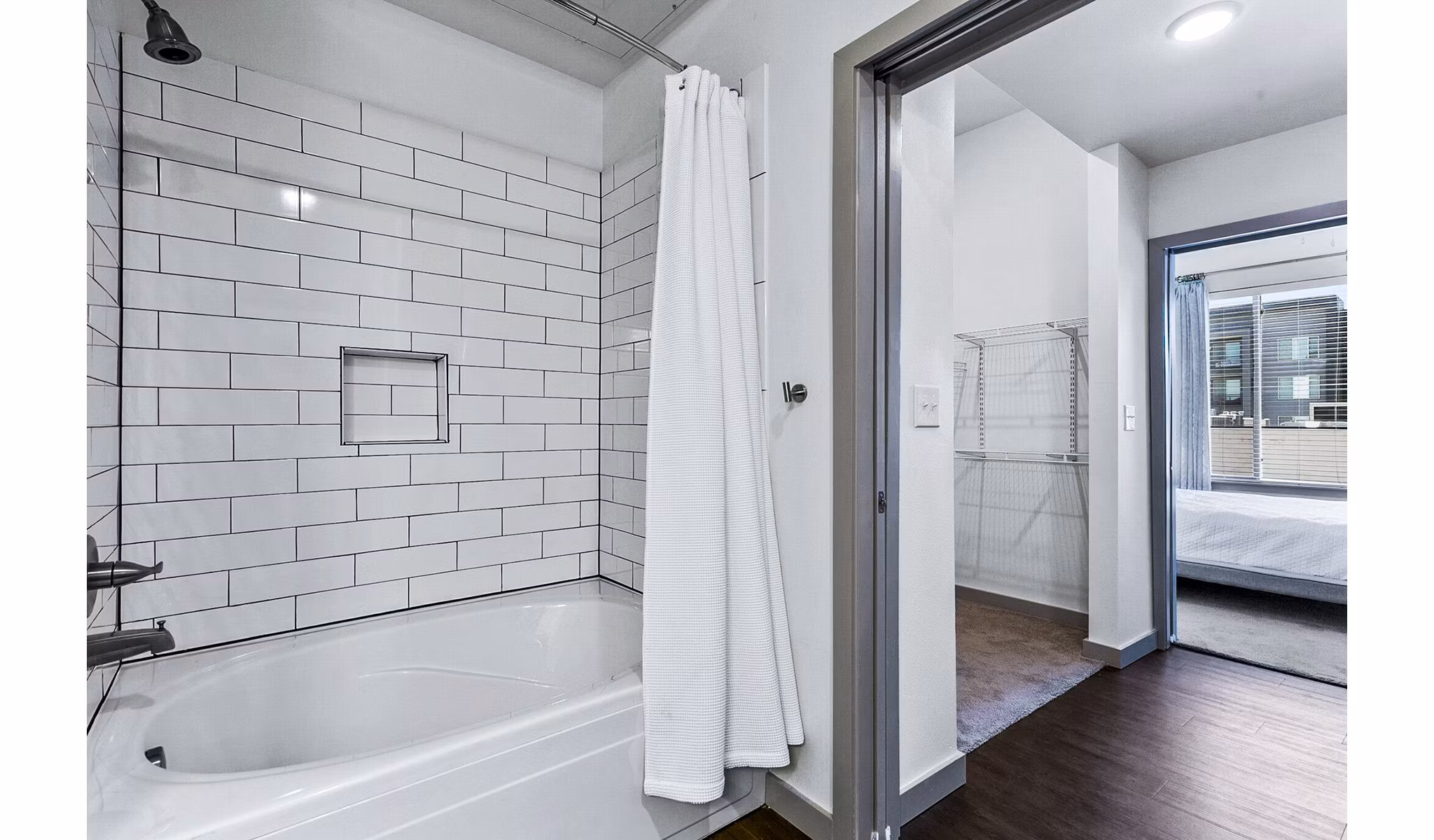 Luxurious bathroom with marble countertops and modern fixtures in West Village Apartments