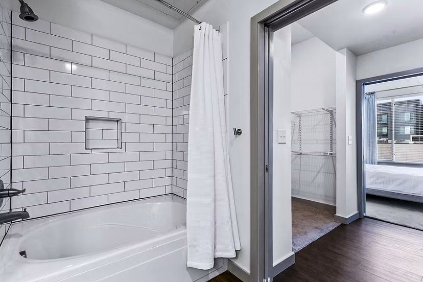 Luxurious bathroom with marble countertops and modern fixtures in West Village Apartments