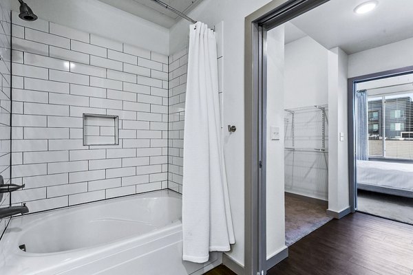 Luxurious bathroom with marble countertops and modern fixtures in West Village Apartments