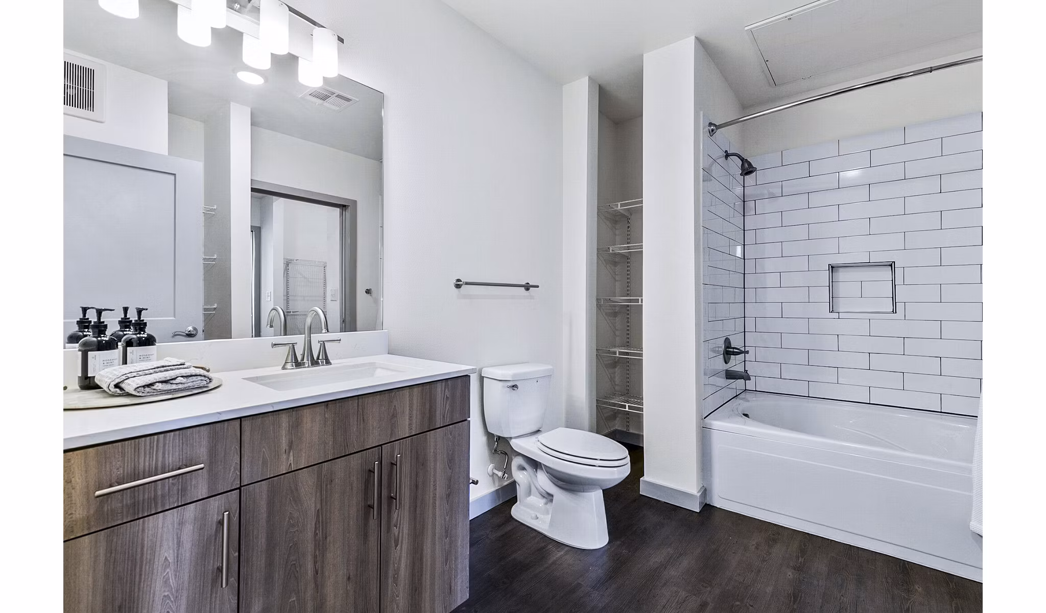 Elegant bathroom with marble countertops and modern fixtures at West Village Apartments