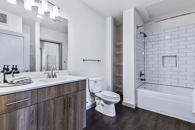 Elegant bathroom with marble countertops and modern fixtures at West Village Apartments