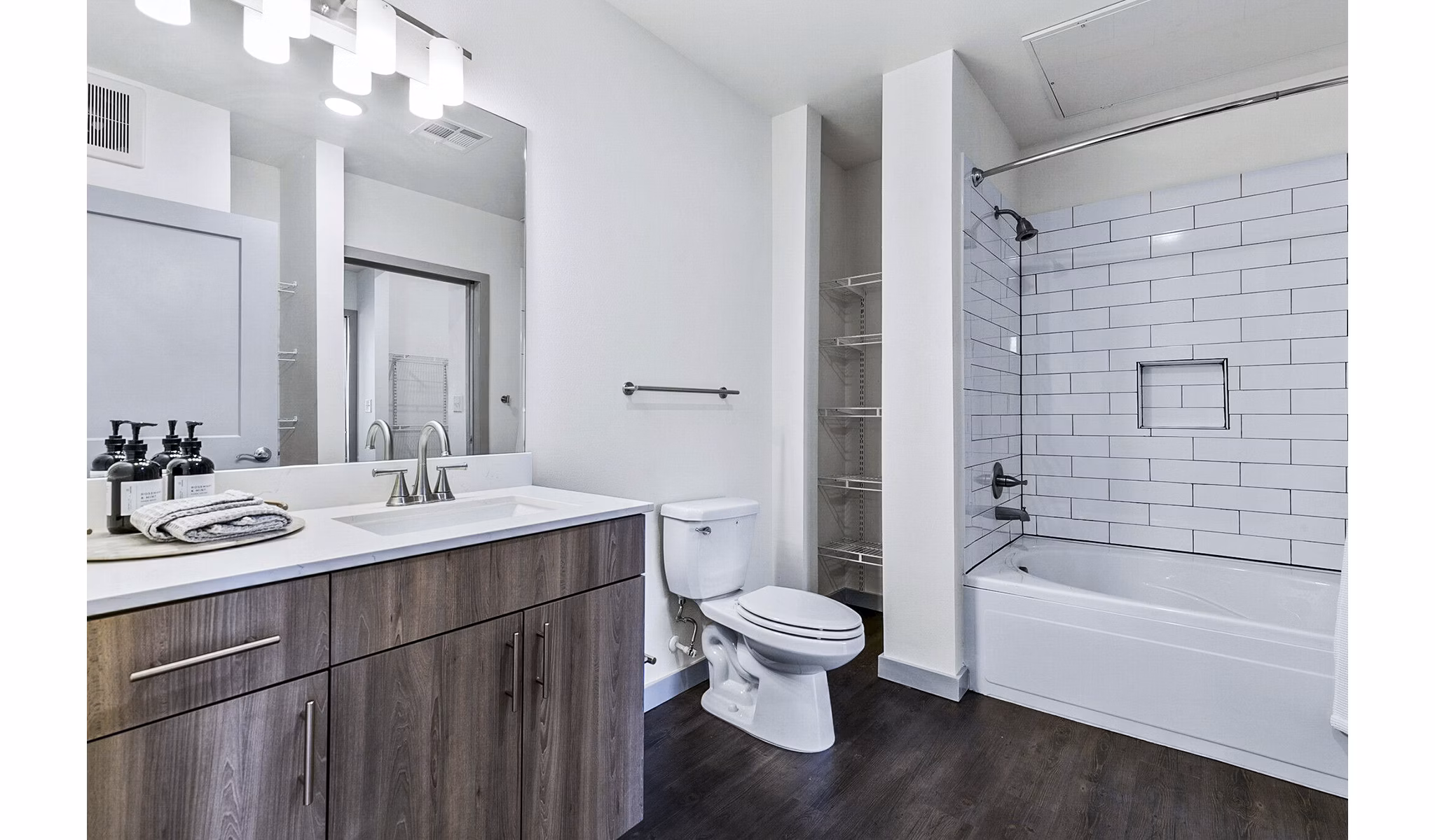 Elegant bathroom with marble countertops and modern fixtures at West Village Apartments
