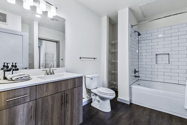 Elegant bathroom with marble countertops and modern fixtures at West Village Apartments