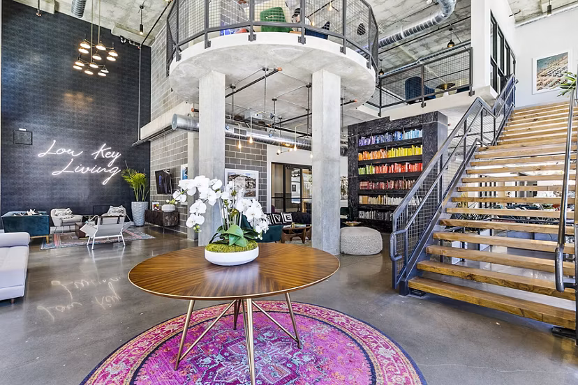 West Village Apartments: Modern clubhouse lobby with contemporary seating and elegant lighting elements in a luxury setting