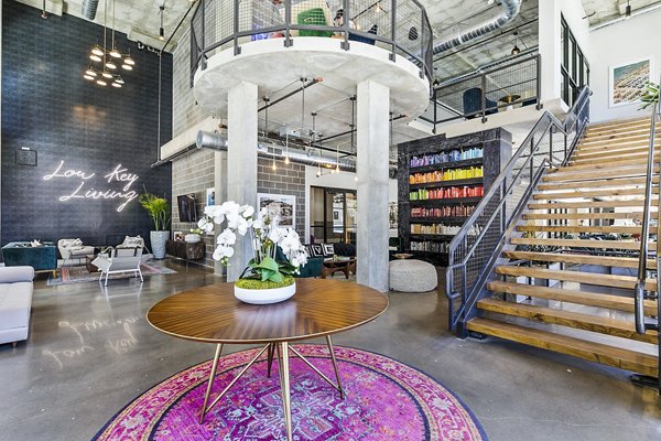 West Village Apartments: Modern clubhouse lobby with contemporary seating and elegant lighting elements in a luxury setting