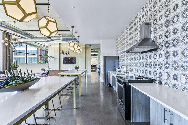 Clubhouse kitchen featuring modern appliances at West Village Apartments, perfect for community gatherings and social events