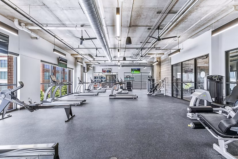 Modern fitness center with state-of-the-art equipment at West Village Apartments