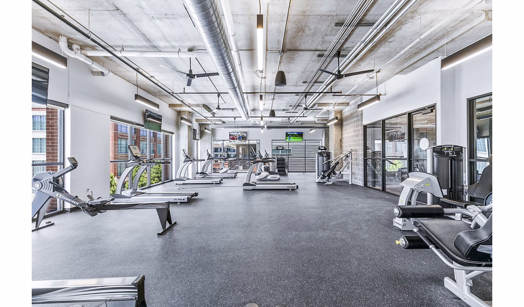 Modern fitness center with state-of-the-art equipment at West Village Apartments