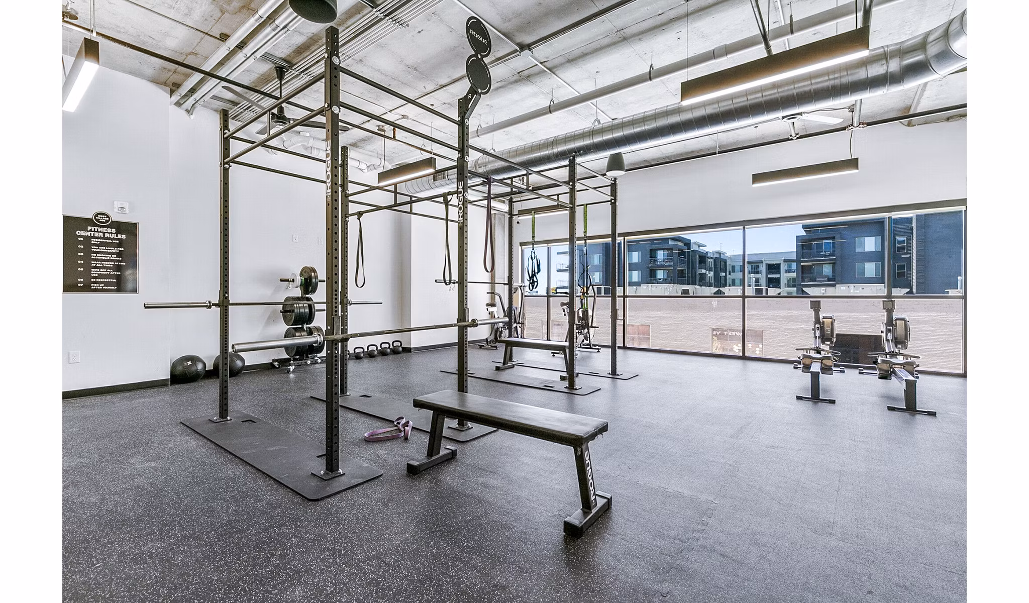 Modern fitness center with state-of-the-art equipment at West Village Apartments