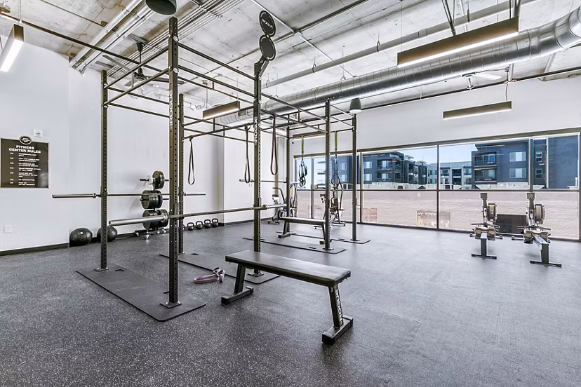 Modern fitness center with state-of-the-art equipment at West Village Apartments