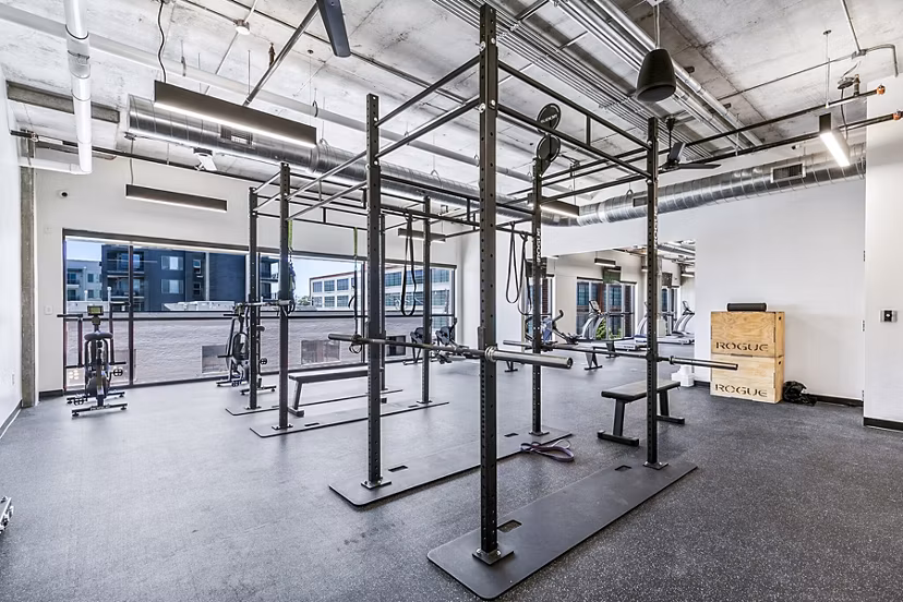 Fitness center with modern equipment at West Village Apartments