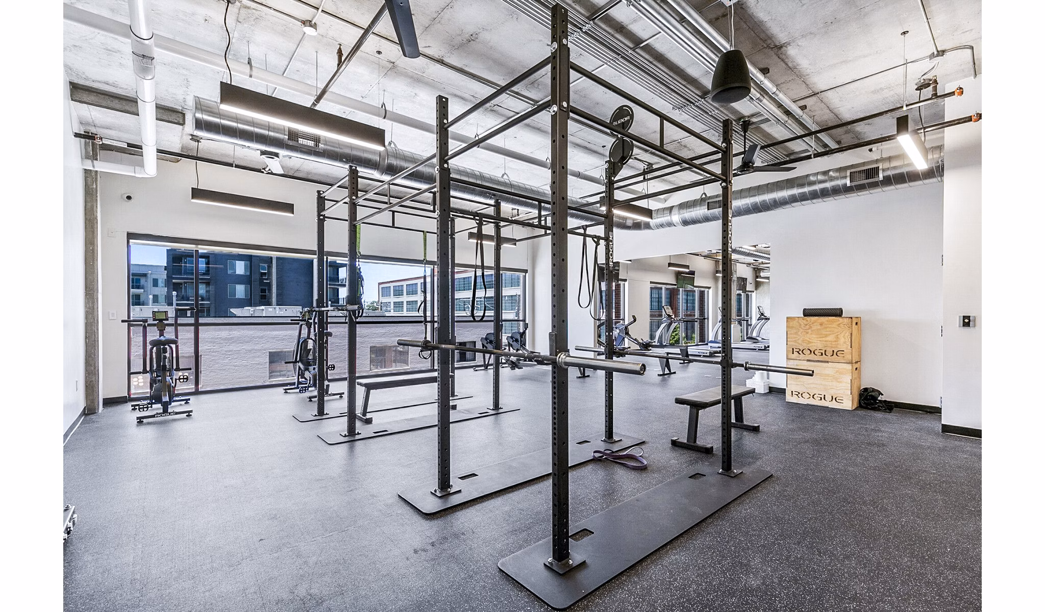 Fitness center with modern equipment at West Village Apartments