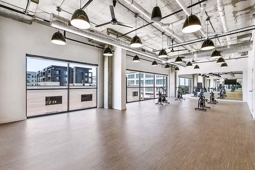 Yoga and spin studio equipped with modern fitness gear at West Village Apartments