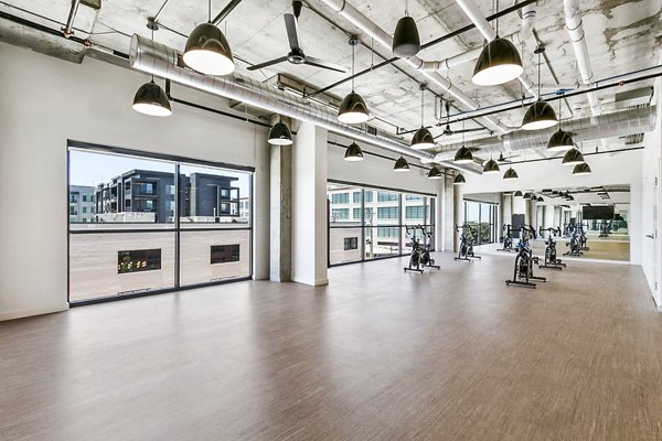 Yoga and spin studio equipped with modern fitness gear at West Village Apartments