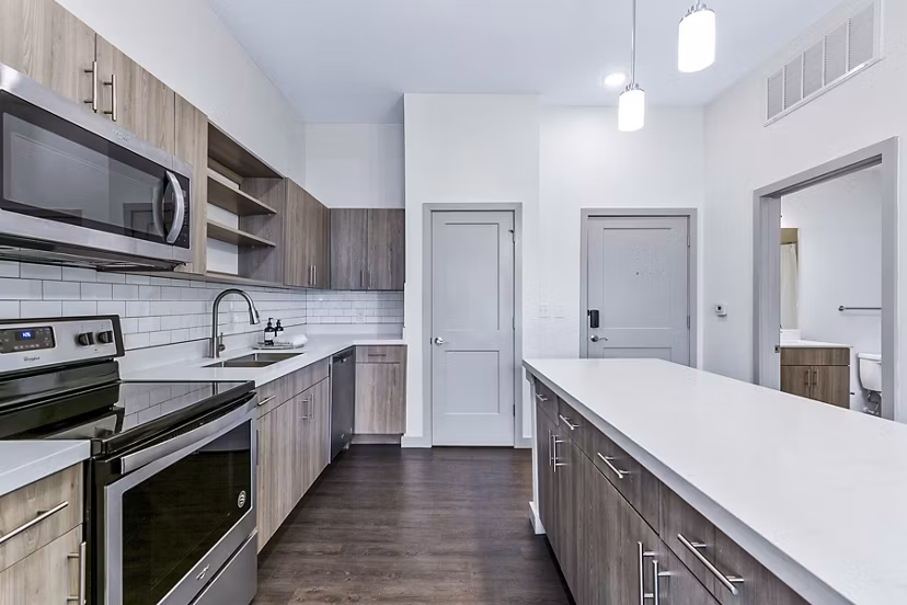 Modern kitchen with stainless steel appliances at West Village Apartments luxury rentals