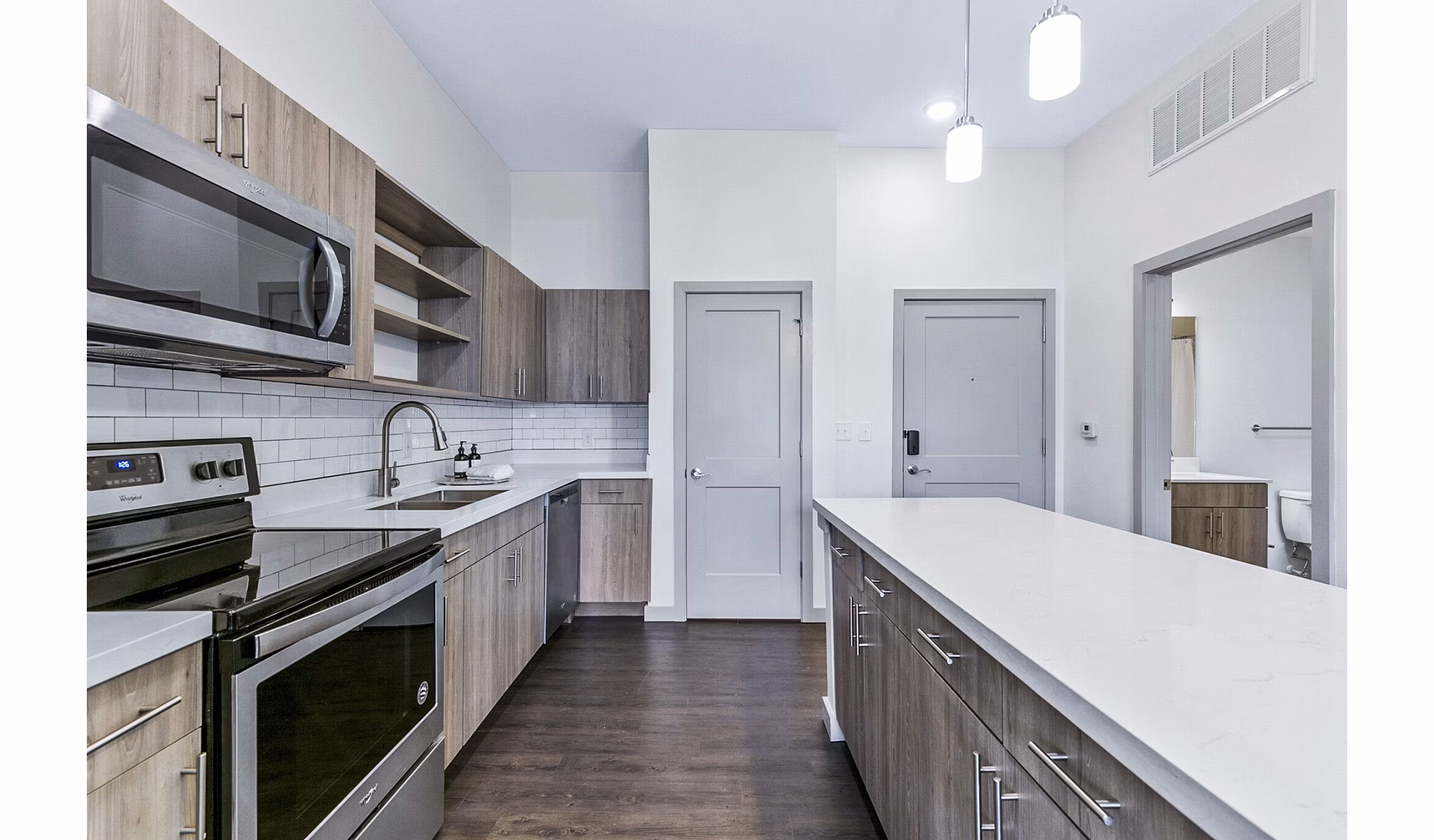 Modern kitchen with stainless steel appliances at West Village Apartments luxury rentals