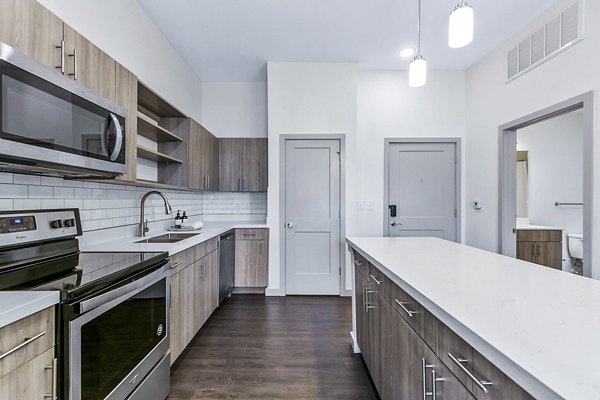 Modern kitchen with stainless steel appliances at West Village Apartments luxury rentals