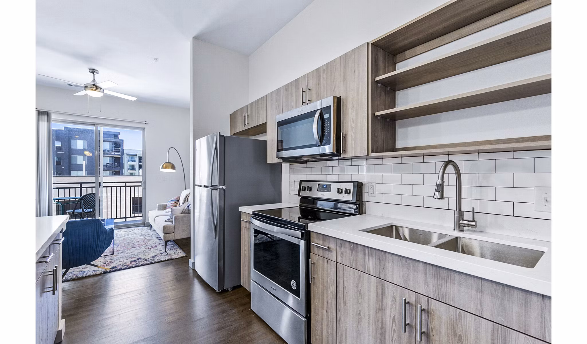 Modern kitchen with stainless steel appliances at West Village Apartments by Greystar