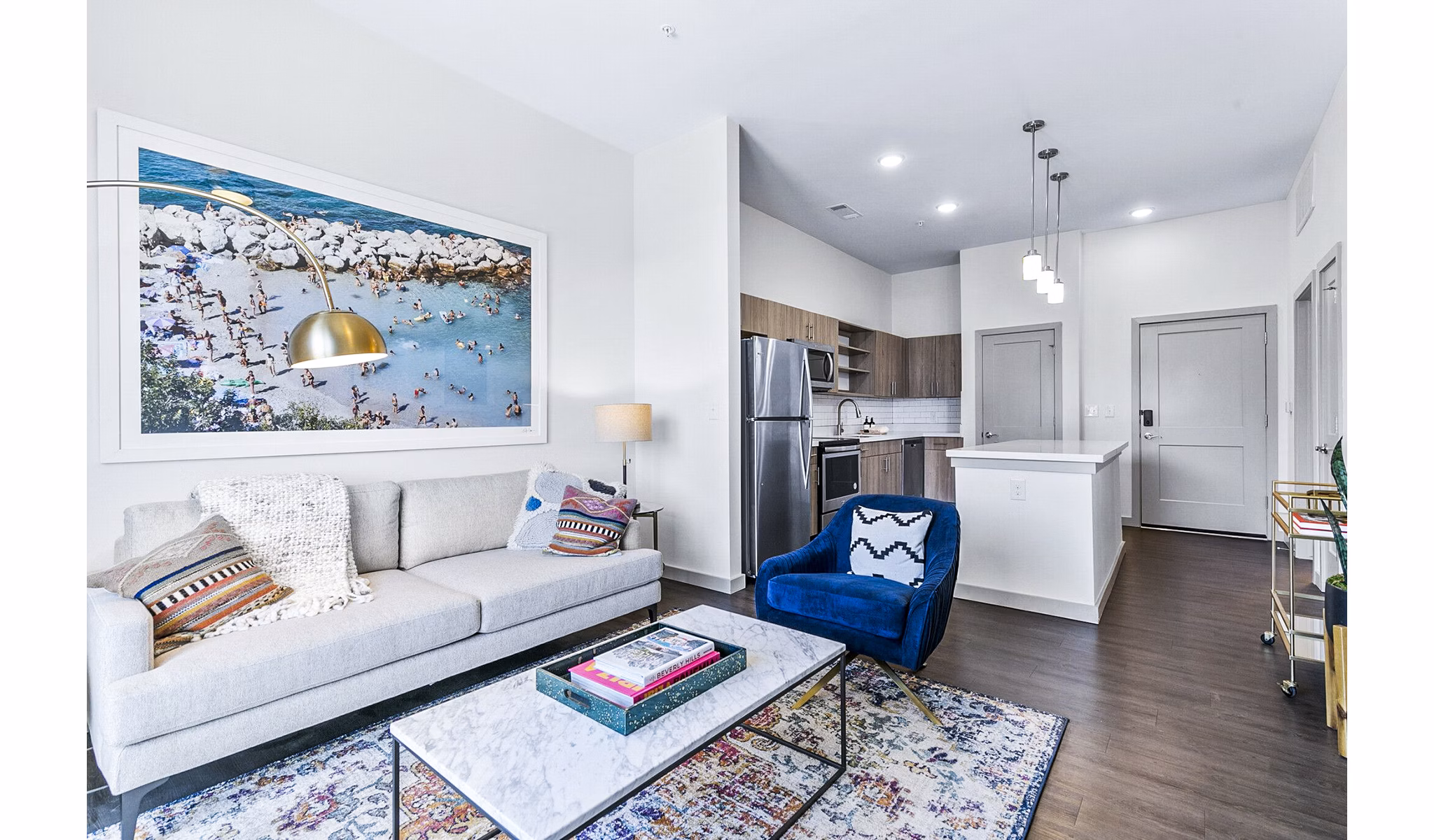 Spacious living room featuring modern decor and cozy seating at West Village Apartments