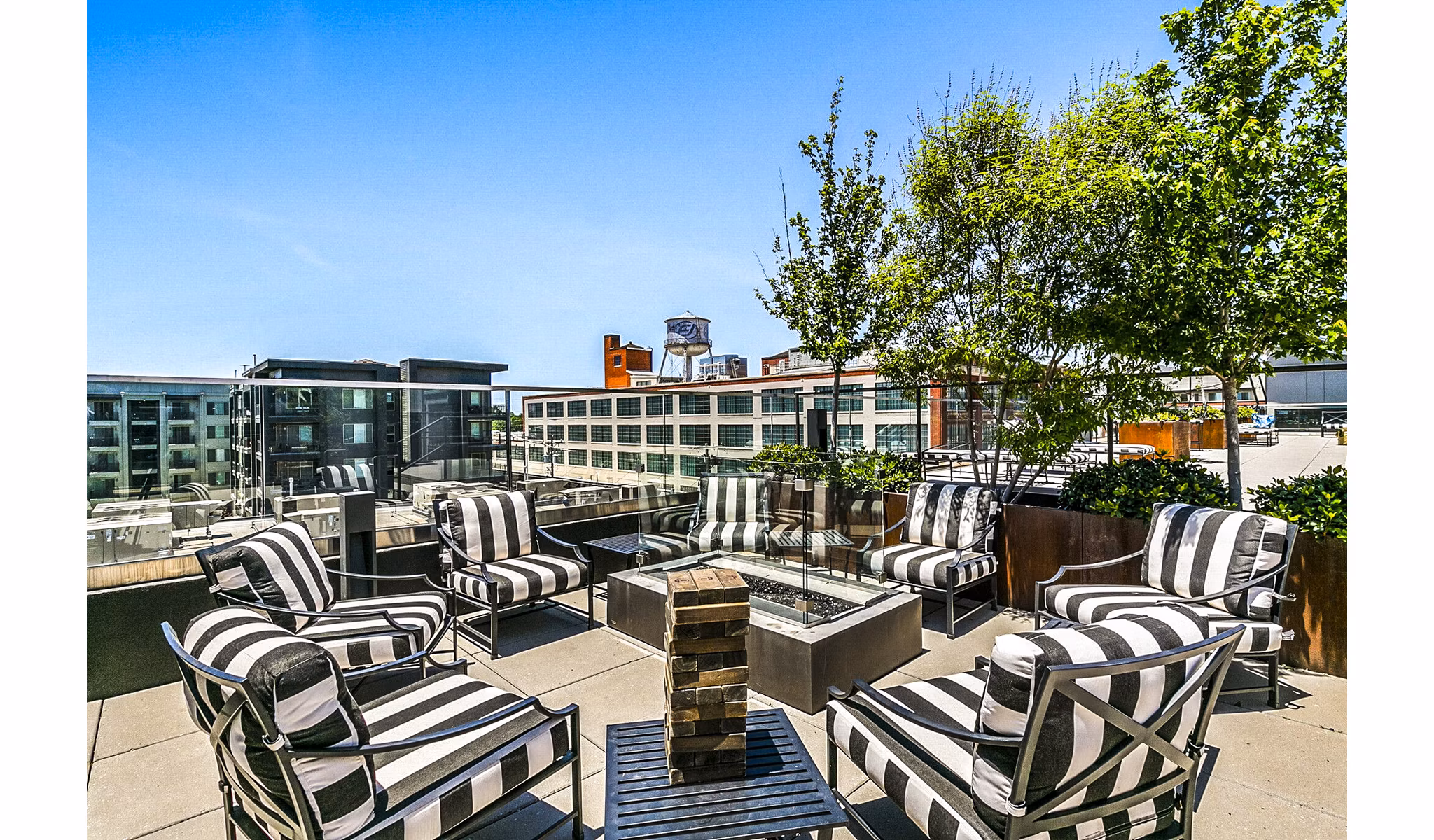 Private patio at West Village Apartments offering scenic garden views and luxury outdoor seating for relaxed living