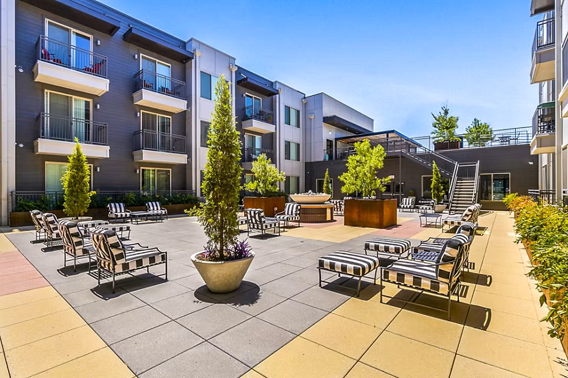Modern courtyard patio with lush greenery at West Village Apartments, a luxury property by Greystar