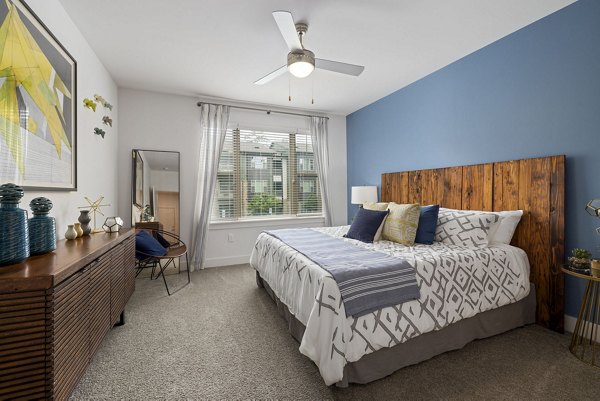 Spacious bedroom with modern decor at The Dakota Apartments, a luxury property offering exceptional living spaces