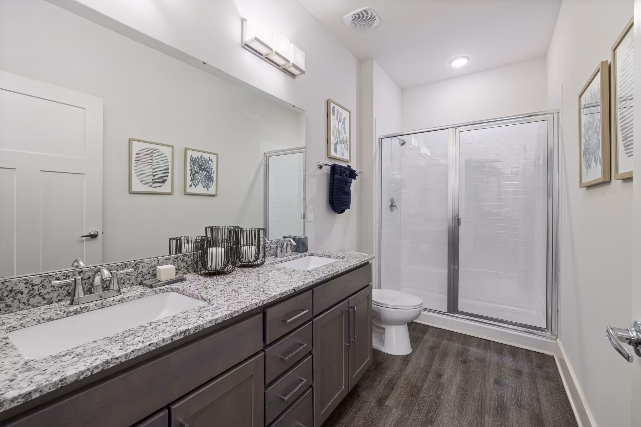 Luxurious bathroom featuring marble countertops and glass shower in The Dakota Apartments