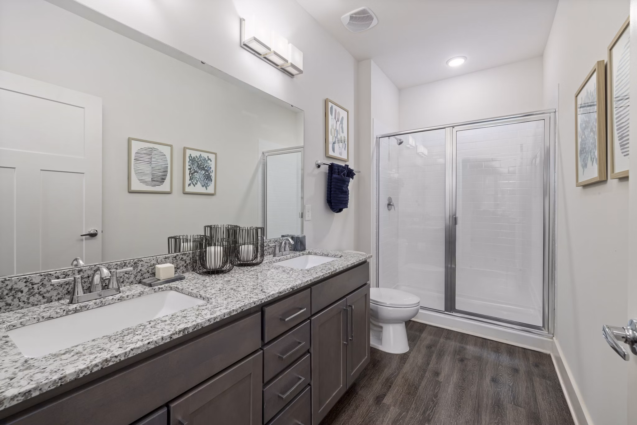 Luxurious bathroom featuring marble countertops and glass shower in The Dakota Apartments