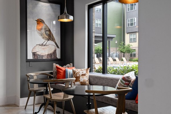 Stylish club house at The Dakota Apartments featuring modern design and ample seating for luxury living