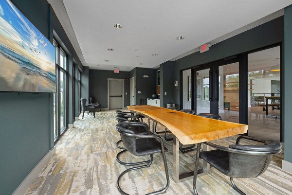 Clubhouse featuring modern furniture and high ceilings at The Dakota Apartments