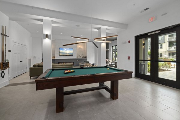 Gaming room with modern consoles and seating at The Dakota Apartments