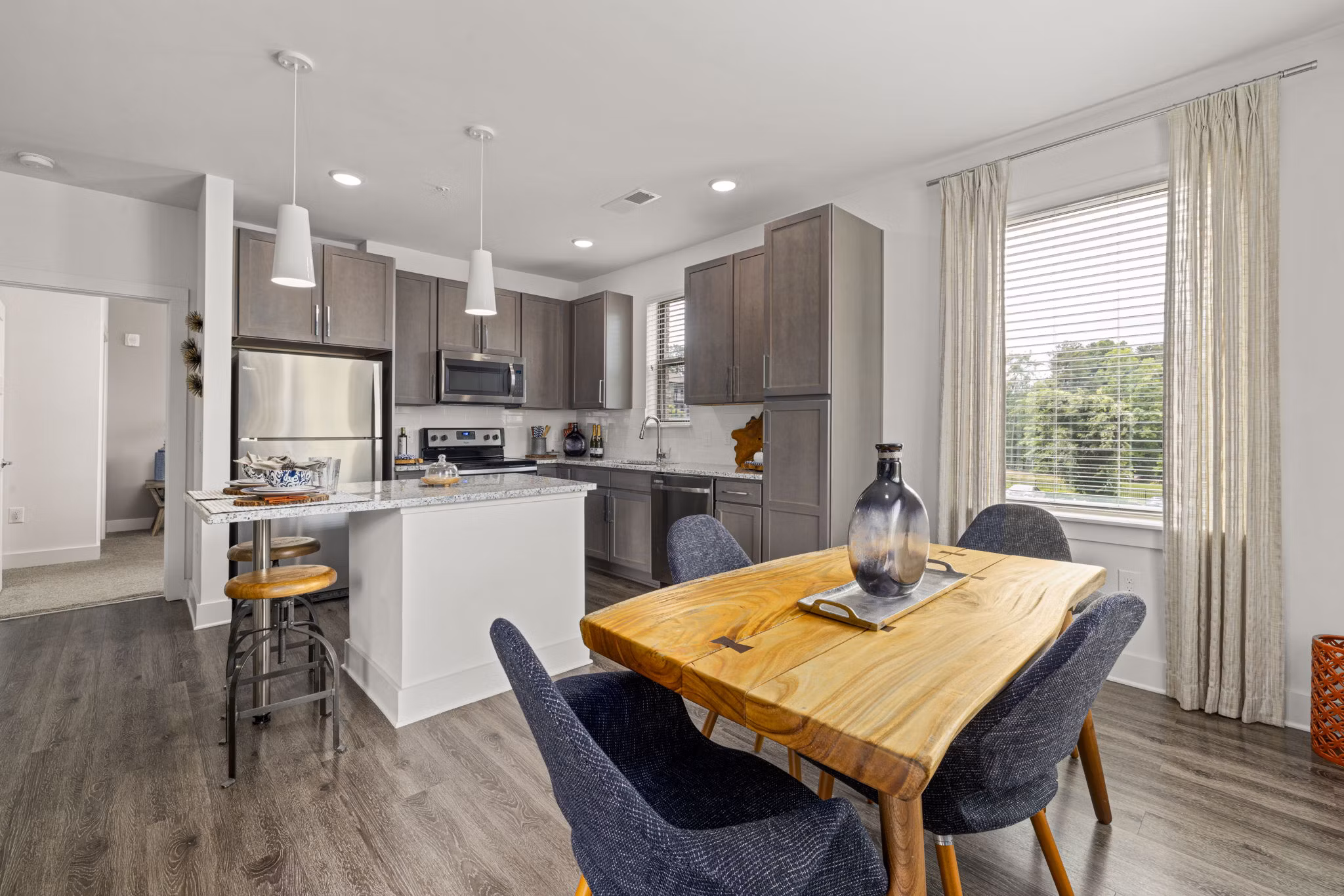 Dining room with modern decor at The Dakota Apartments, featuring elegant lighting and contemporary furnishings Luxury living in city center