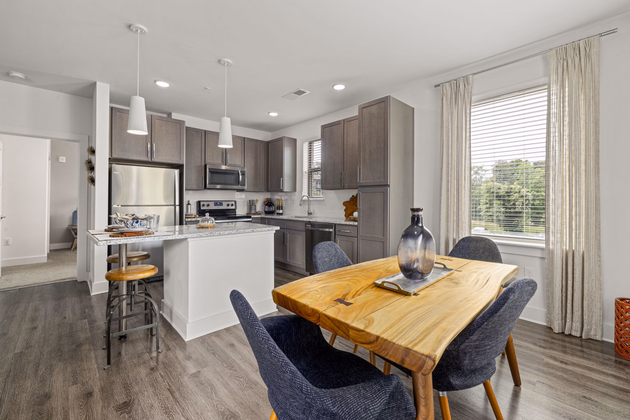 Dining room with modern decor at The Dakota Apartments, featuring elegant lighting and contemporary furnishings Luxury living in city center