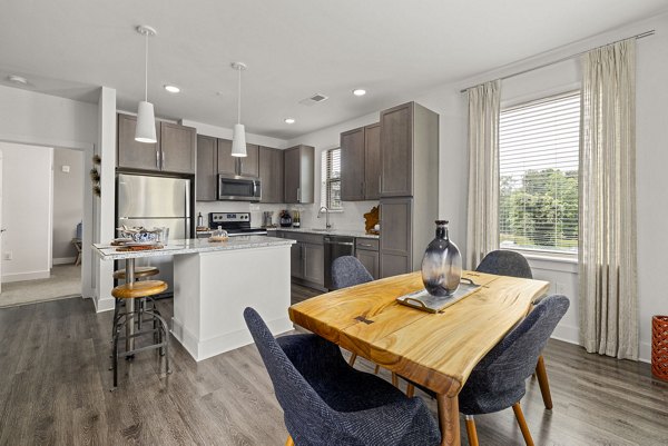 Dining room with modern decor at The Dakota Apartments, featuring elegant lighting and contemporary furnishings Luxury living in city center