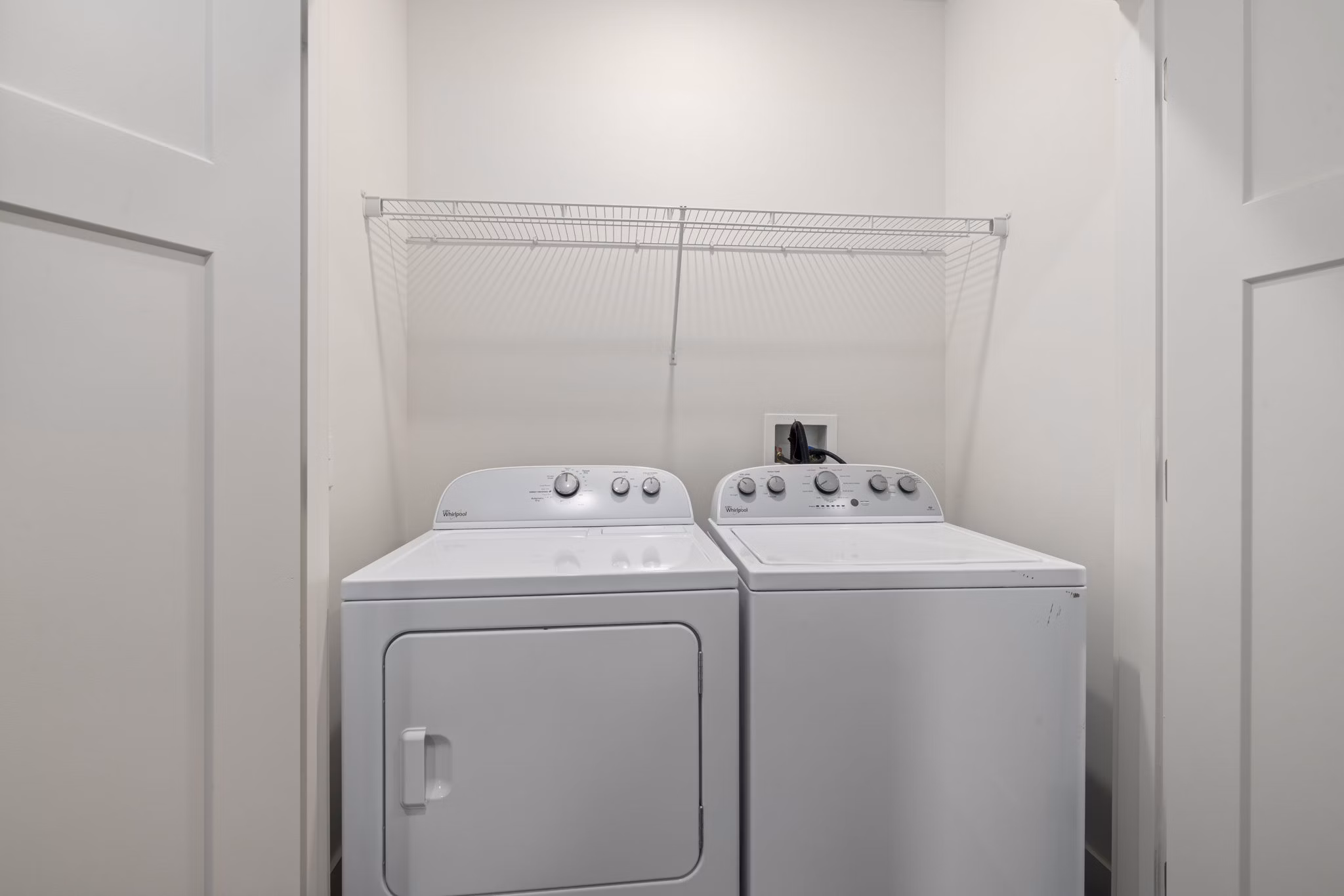 Laundry room with high-efficiency washers and dryers at The Dakota Apartments