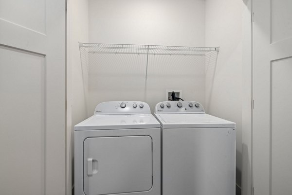 Laundry room with high-efficiency washers and dryers at The Dakota Apartments