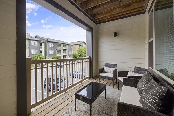 Residence patio with comfortable seating and lush greenery at The Dakota Apartments