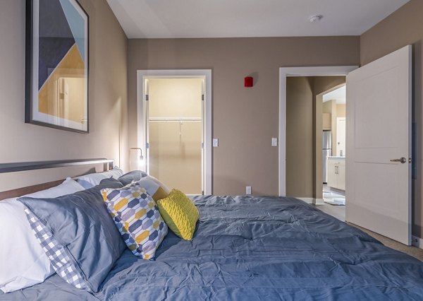 Spacious bedroom with neutral tones featuring modern furnishings at Elan Yorktown Apartments