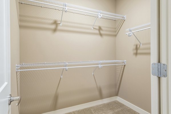 Walk-in bedroom closet with custom shelving at Elan Yorktown Apartments, perfect for organizing and maximizing luxury apartment space