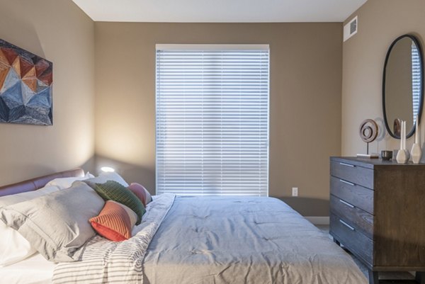 Cozy bedroom with modern furnishings at Elan Yorktown Apartments