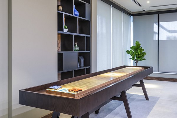 Clubhouse game room with pool table and lounge seating at Elan Yorktown Apartments